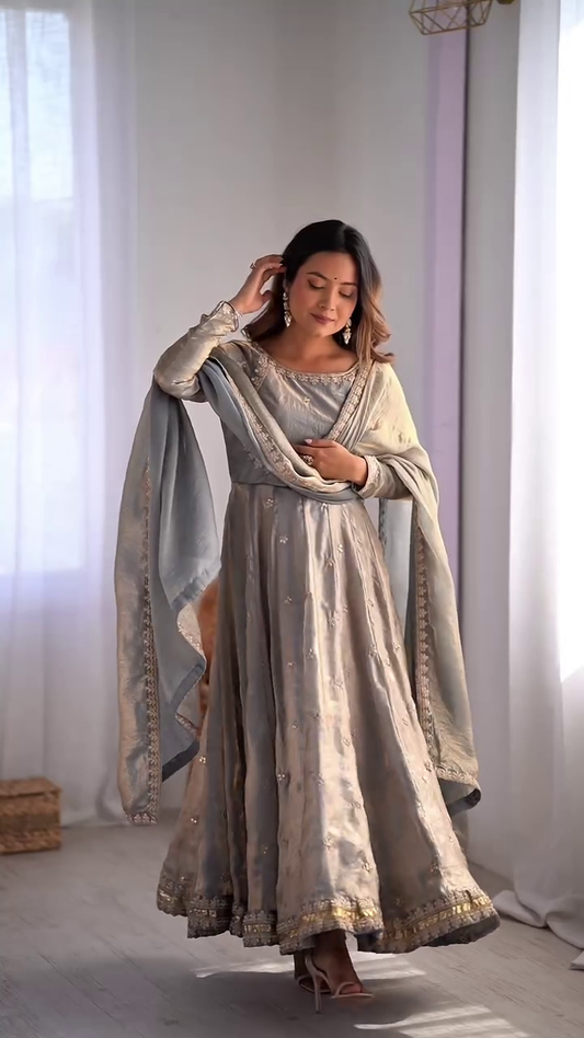 Graceful Light Blue Embroidered Anarkali Dress with Delicate Floral Motifs and Golden Borders, Paired with a Matching Dupatta