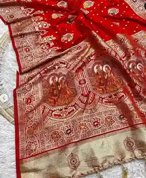 Banarasi silk saree with intricate weaving and a border featuring images of religious figures