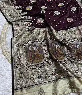 Banarasi silk saree with intricate weaving and a border featuring images of religious figures